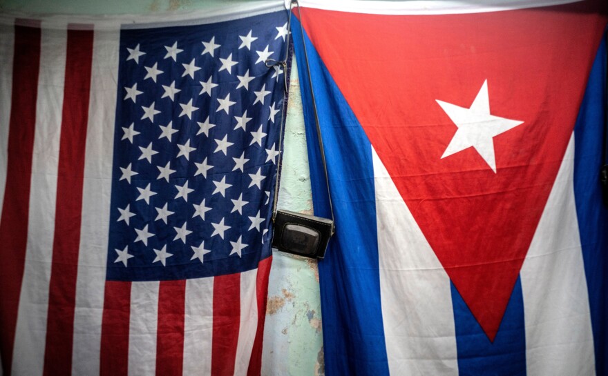 FILE - A U.S. and Cuban flag hangs on a wall in Havana, Cuba, Monday, Jan 11, 2021.