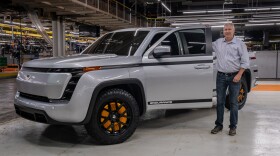 Lordstown Motors CEO Steve Burns stands next to his company's all electric Endurance pickup.