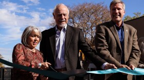 (From left to right) Governor Michelle Lujan Grisham, Albuquerque City Council President Isaac Benton and Albuquerque Mayor Tim Keller cut the ribbon to "open" The Commons at Martineztown
