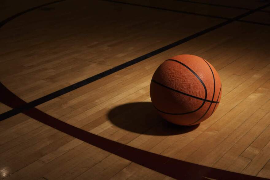 A basketball sits on a basketball court. (Thomas Northcut/Getty Image)