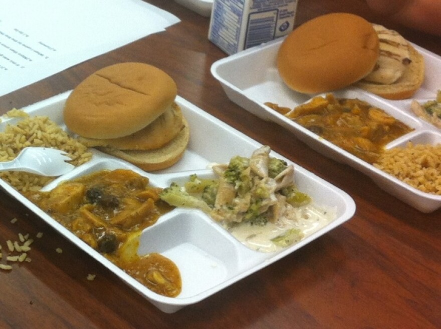 New school lunch options at school no. 19. It includes a grilled chicken sandwich, broccoli alfredo, rice and curry chicken with raisins.