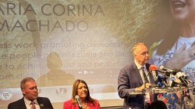Marcell Felipe, chairman of the American Museum of the Cuban Diaspora, speaks Monday morning in honor of Venezuelan Nobel Peace laureate Maria Corina Machado, as Miami-Dade College President Madeline Pumariega (center) and St. Thomas University President David Armstrong look on.