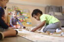 A child plays with a train set at Bumble Art Studio day care center in Astoria, Ore., Friday, Sept. 2, 2022. (Craig Mitchelldyer/AP)