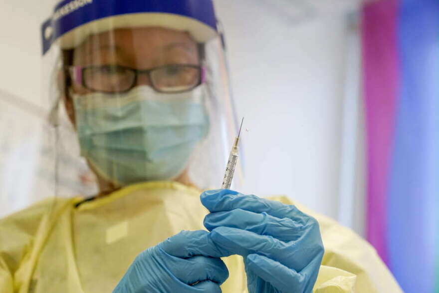 FILE - A physician assistant prepares a syringe with the monkeypox vaccine for a patient during a vaccination clinic Friday, Aug. 19, 2022, in New York. The disease’s spread is slowing but the virus is unlikely to be eliminated because it is widespread enough that spread of the disease is expected to continue, the Centers for Disease Control and Prevention said in late September 2022. (AP Photo/Mary Altaffer, File)