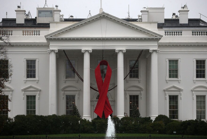 A red ribbon is displayed on the North Portico of the White House to recognize World AIDS Day in 2015. (Mark Wilson/Getty Images)