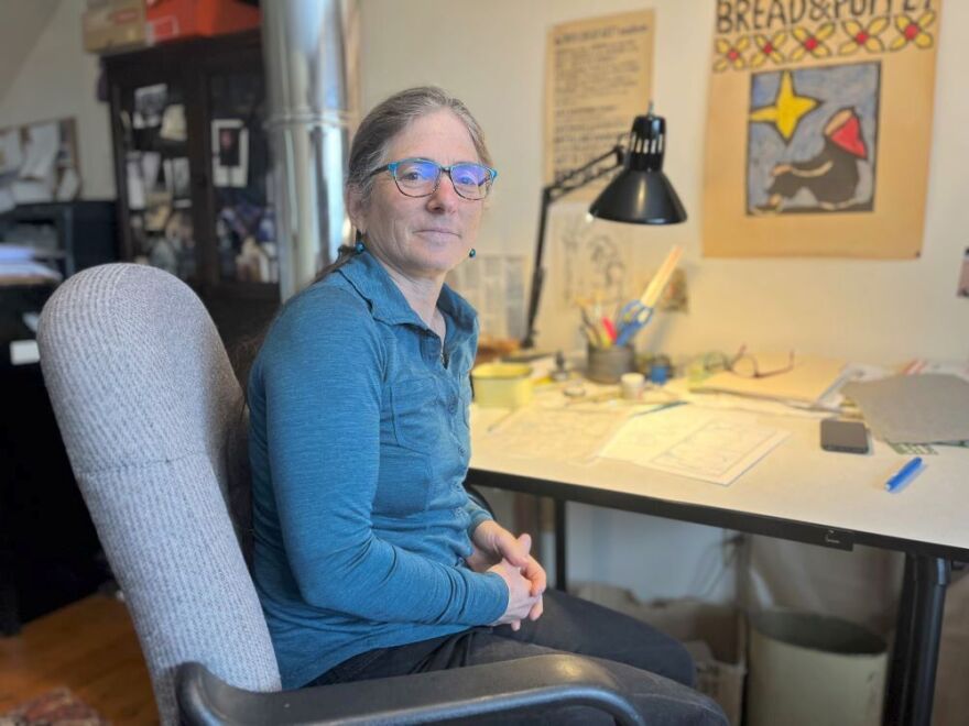Bernstein at the desk where she draws maps and other illustrations.