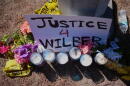 Flowers and candles are seen near the site where a Venezuelan man was shot in his vehicle by an ICE officer in Austin, Texas, Monday, Sept. 21, 2026. (Eric Gay/AP)