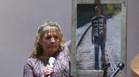 Barb Foley holds a photo of her son Kyle, who died from an overdose in July, while talking to students at Brown County High School.