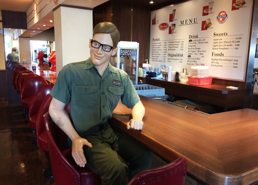A replica of an American serviceman that sits at the counter of the diner-like Blue Seal ice cream shop.