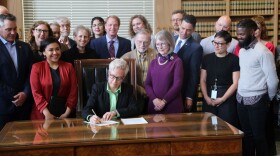 Governor Tina Kotek participates in a signing ceremony for a new law that will regulate campaign finance in Oregon for the first time in decades.