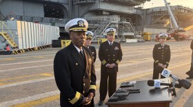 Rear Adm. Alexis Walker, commander of the USS Bush Carrier Strike Group, takes questions before departing Norfolk.