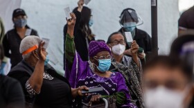 At a Kedren Community Health Center vaccine clinic in South Central Los Angeles this month, 89-year-old Cecilia Onwytalu (center) signals she's more than ready to get her immunization against COVID-19.