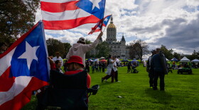 Guests gather for the Festival del Coqui following the Greater Hartford Puerto Rican Day Parade Sunday Oct. 8, 2023. Thousands marched and gathered along the parade route that finished in Bushnell Park, in the shadow of the Connecticut State Capitol.