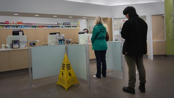 People wait in line at a Walgreens pharmacy in Roseville on Thursday, March 26, 2026.