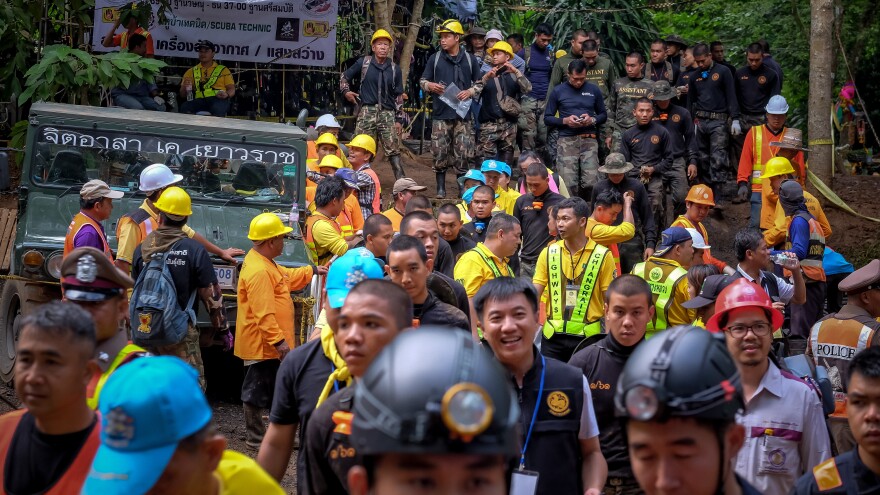 Hundreds of rescuers gather outside the cave Tuesday in Chiang Rai to help load equipment and aid efforts to rescue the 12 boys aged 11 to 16 and their 25-year-old coach.