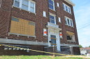 An apartment building is boarded up.