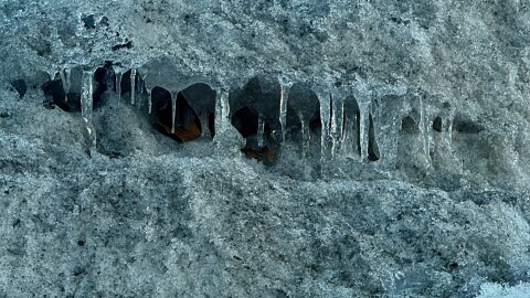 Icicles hang from inside a parking lot snow pile near the Twin Cities on Feb. 6, 2026.