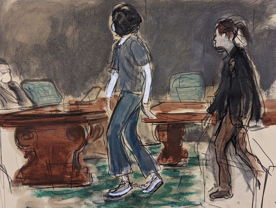 In this courtroom sketch, Ghislaine Maxwell is escorted by a U.S. Marshal as she wears leg shackles and enters the courtroom for her sentencing in federal court on June 28, 2022 in New York. 