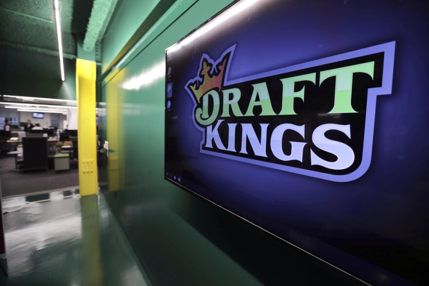 Large DraftKings logo is displayed on a wall
