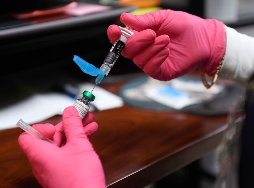 FILE - Anna Hicks prepares a measles, mumps and rubella vaccine at the Andrews County Health Department, Tuesday, April 8, 2025, in Andrews, Texas.