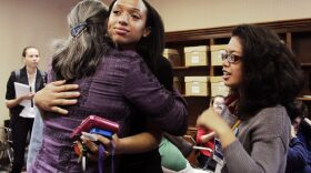 Brianna Williams, volunteer, hugs Helen Warren, candidate for City Commission At-Large seat 2, when election results revealed she's in the run-off election against Annie Orlando on April 8.