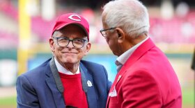 Ohio Gov. Mike DeWine, left, speaks with Hall of Fame broadcaster Marty Brennaman before a baseball game.
