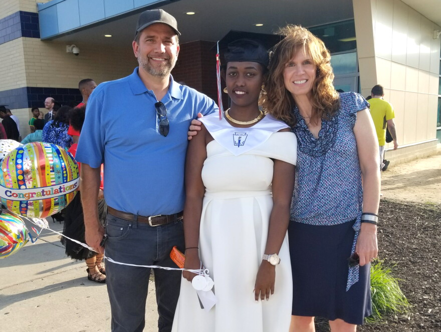 Aline Umwamikazi, on the day she graduated from Belmont High School. She's pictured here with her friend Jamie Cason and Jamie's husband.