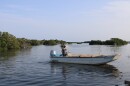 Skiffs topped with wooden “culling boards”, used to sort, clean and measure oysters, return to the dock after dropping off loads of limestone for a reef restoration project. (Rose Schnabel/WUFT News)