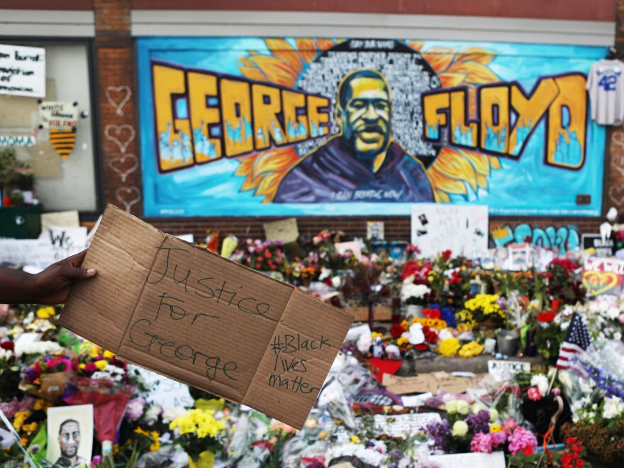 People gather at the site in Minneapolis where Floyd was killed while in police custody.