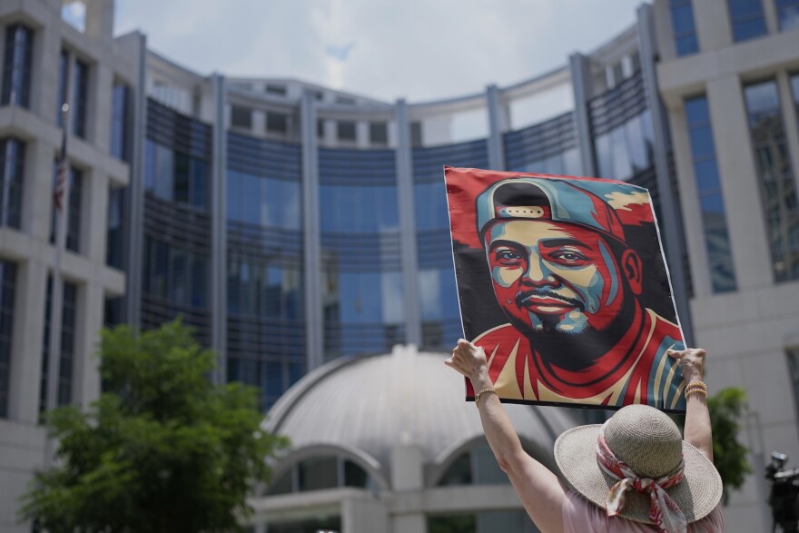 Katheryn Millwee holds a portrait of Kilmar Abrego Garcia outside the federal courthouse Wednesday, June 25, 2025, in Nashville, Tenn. Photo: George Walker IV/AP
