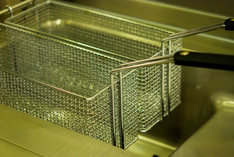 An empty deep fryer.
