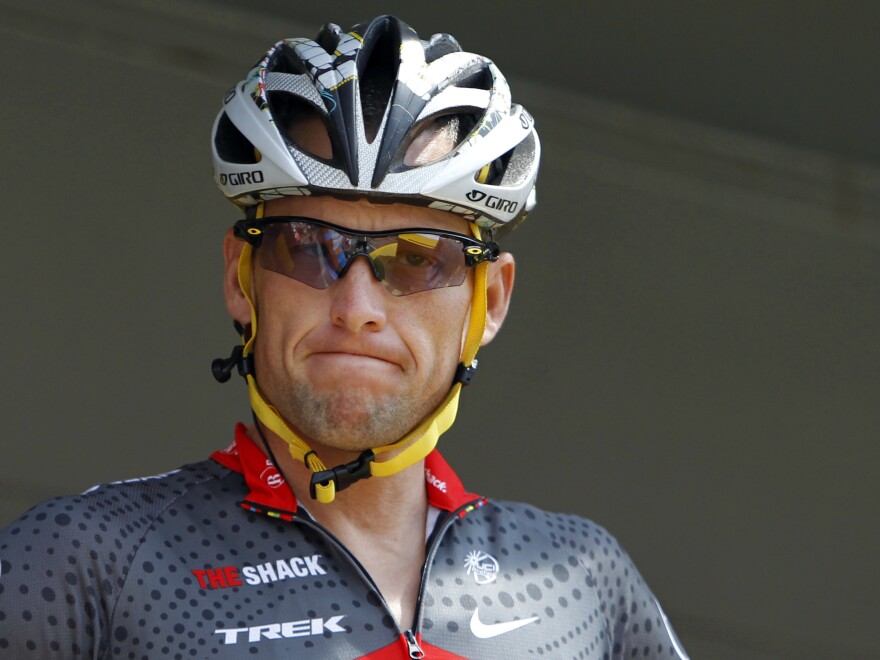 Lance Armstrong grimaces prior to the start of the third stage of the Tour de France cycling race in Wanze, Belgium, on July 6, 2010. Armstrong said Thursday he is finished fighting charges from the U.S. Anti-Doping Agency that he used performance-enhancing drugs during his unprecedented cycling career.