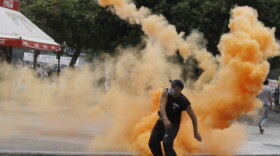 A protester throws a missile at riot police during clashes in central Athens on Wednesday during the Greek Austerity vote. Protests continue even after the Parliament voted for the bill.