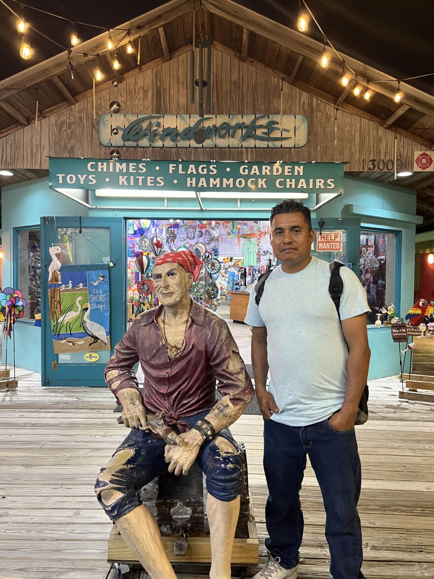 Adelaido Chavez Mariano stands next to a statue of a pirate during a family trip in 2023.