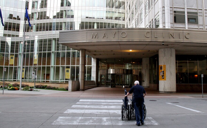Mayo Clinic employee Merle Paxton returns wheelchairs to a building on campus.