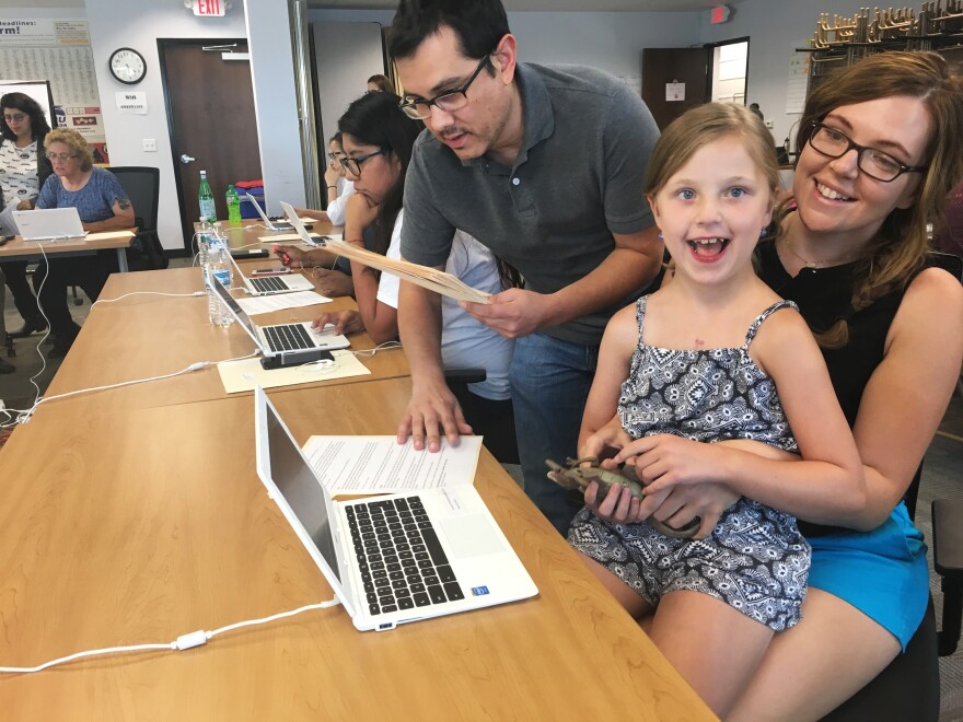 Taylor Lewis sits with her 7-year-old daughter Riley. Until Taylor finds a full-time job, she says she depends on Medicaid to cover all of her daughter's medical costs.