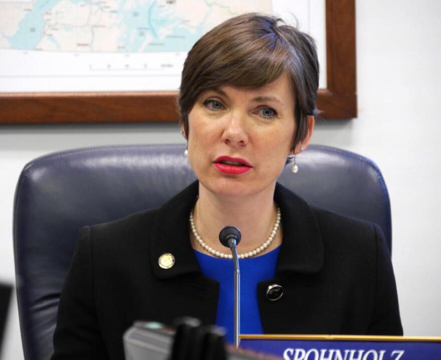 A woman speaks into a microphone.
