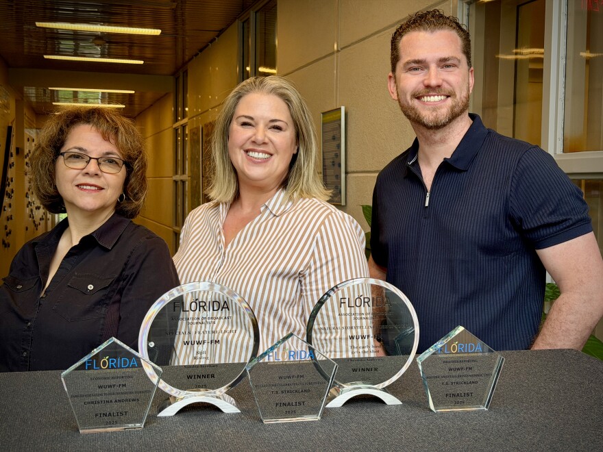 WUWF staff Sandra Averhart, left, Christina Andrews, middle, and T.S. Strickland, right, after receiving the highest number of Florida News Awards in station history.