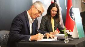Shaun Gleason, Director of Partnerships at Oak Ridge National Laboratory, left - and Tasia Malakasis, CEO of The Company Lab, right - sign a memorandum of understanding in Chattanooga on July 8th, 2026.