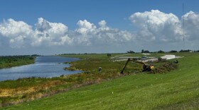 Material from a floating island (Called a tussock) continues to keep a Lake Okeechobee channel near Route 2 closed. Heavy equipment is being used to remove the material.