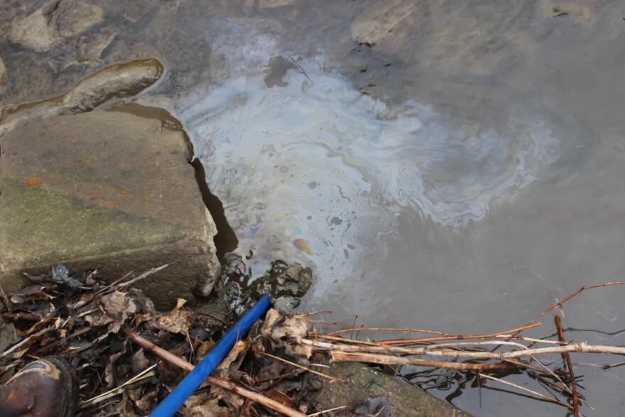 On March 13, 2023, Danny Bostwick stirred up the sediment in Sulfur Run with a blue pole. Bubbles and a sheen appeared on the surface.