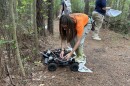 ODU master's student Willow Baker sets up a 'TickBot' prototype on a neighborhood trail in Chesapeake on July 27, 2026.