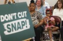 Doreen Young, a curbside ambassador with Foodlink's Curbside Market and her granddaughter, Bailey Thomas, wait for U.S. Senator Chuck Schumer to begin a press conference Tuesday, May 27, at the 3rd Presbyterian Church Food Cupboard in Rochester. Young who used SNAP benefits to raise her family as a working single mother spoke about her concern for families with food insecurity will be impacted by the House spending bill that cut $300 billion cut to SNAP funding. The federal government's SNAP program is the United States primary anti-hunger program that provides thousands of seniors, families, and children from going hungry by providing financial assistance to purchase food.