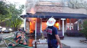 Firefighters combat a four-alarm blaze that destroyed three Arlington small businesses Monday evening.