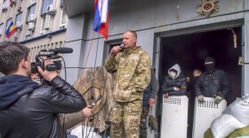 A pro-Russian activist speaks at the Security Services building, which was seized in Luhansk, eastern Ukraine. The standoff is one of three taking place in the region, and Luhansk is considered particularly volatile because the Security Services building contains many weapons.