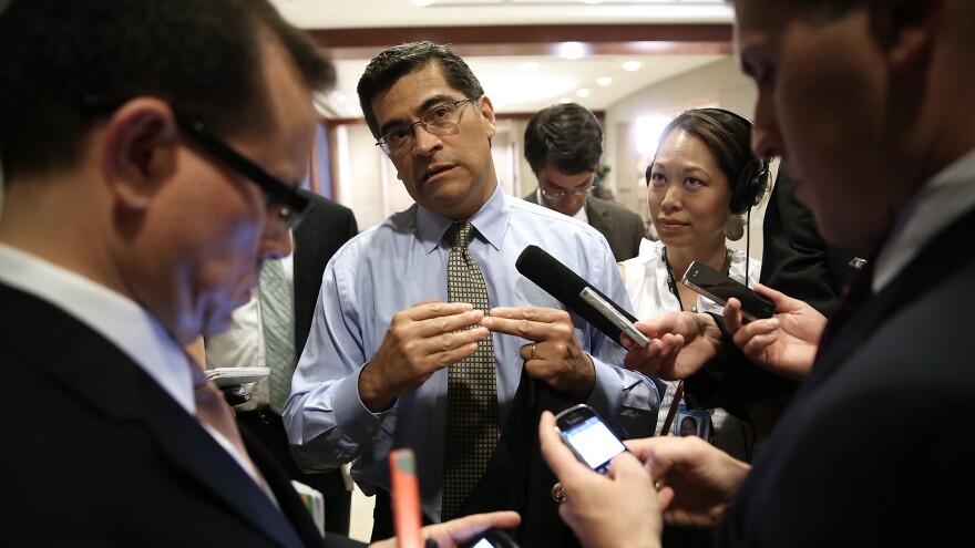 Rep. Xavier Becerra speaks to members of the media as he arrives at a closed briefing for members of the House of Representatives in 2013.