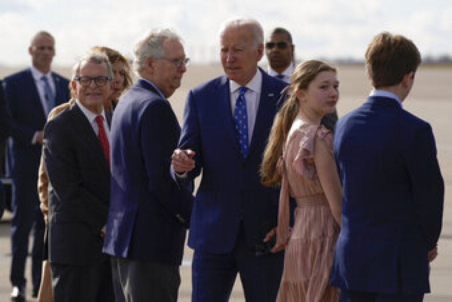 President Joe Biden is greeted by Senate Minority Leader Mitch McConnell of Ky., Ohio Gov. Mike DeWine, and others as he arrives at Cincinnati/Northern Kentucky International Airport in Hebron, Ky., Wednesday, Jan. 4, 2023. Kentucky Gov. Andy Beshear's children Will and Lila look on. (AP Photo/Patrick Semansky)