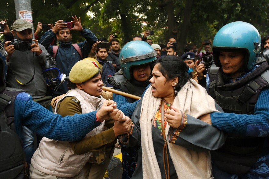 Police detain a demonstrator in New Delhi in December 2019. Countrywide protests continued throughout India in December as public anger grew over new changes to citizenship laws.