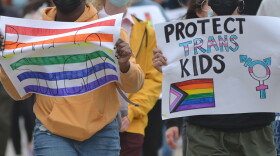 Marchers in Kansas City protest with students from Crossroads Preparatory Academy on April 13, 2022 who walked out of class to protest anti-LGBTQ bills in the Missouri legislature.