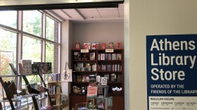 The doorway into a small shop filled with books.